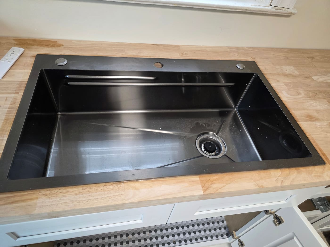 Black stainless workstation sink installed by Panther Plumbing
