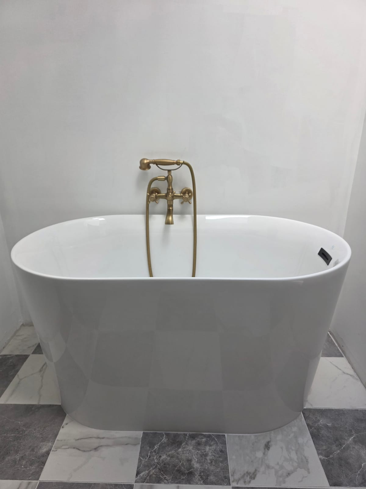 Finished freestanding soaker tub install by Panther Plumbing in a remodeled bathroom