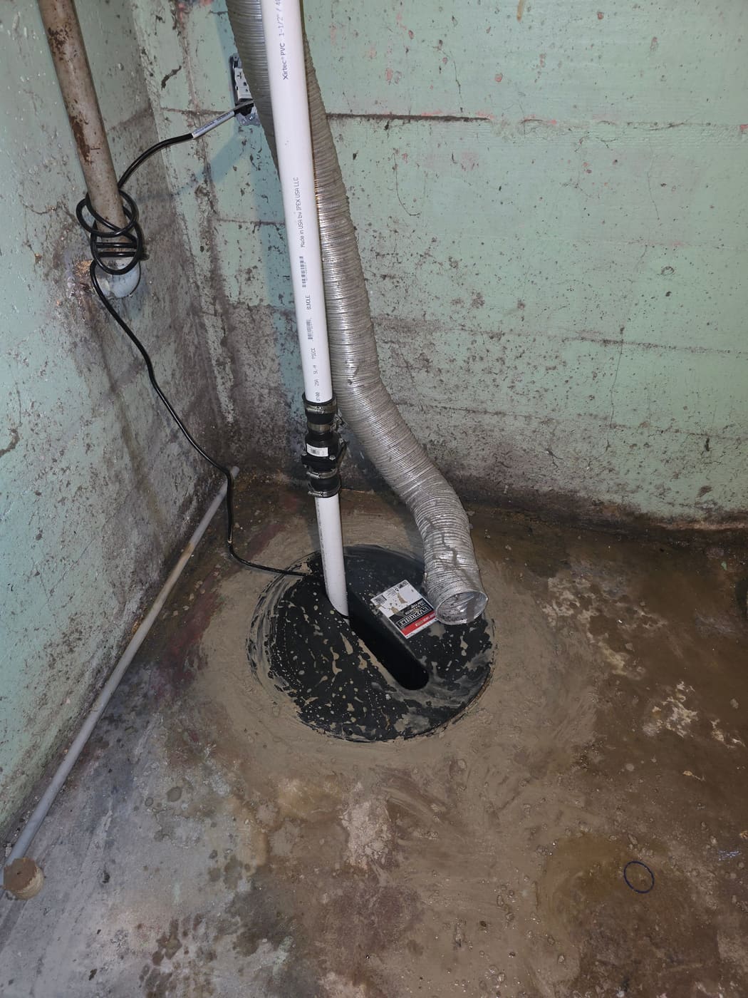 Sump pump installation in a basement crock by Panther Plumbing
