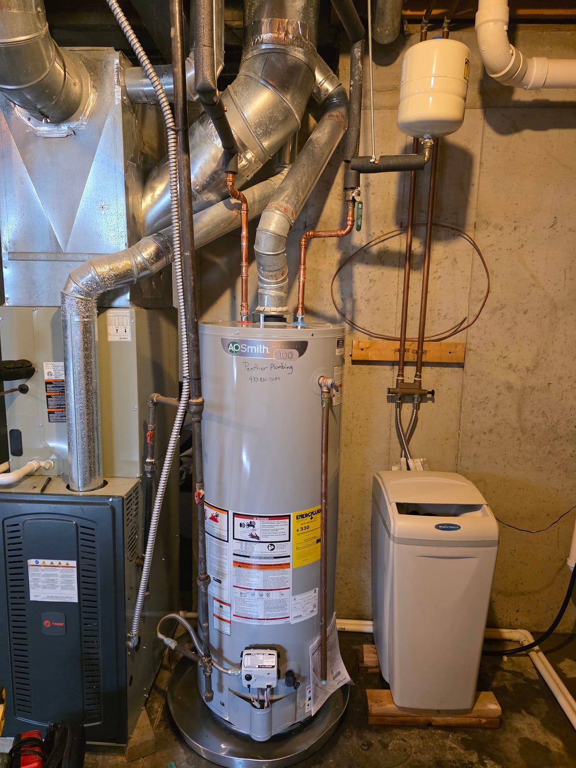 A.O. Smith gas water heater installed by Panther Plumbing beside a Trane furnace, with new copper supply lines, an expansion tank, and a WaterBoss water softener